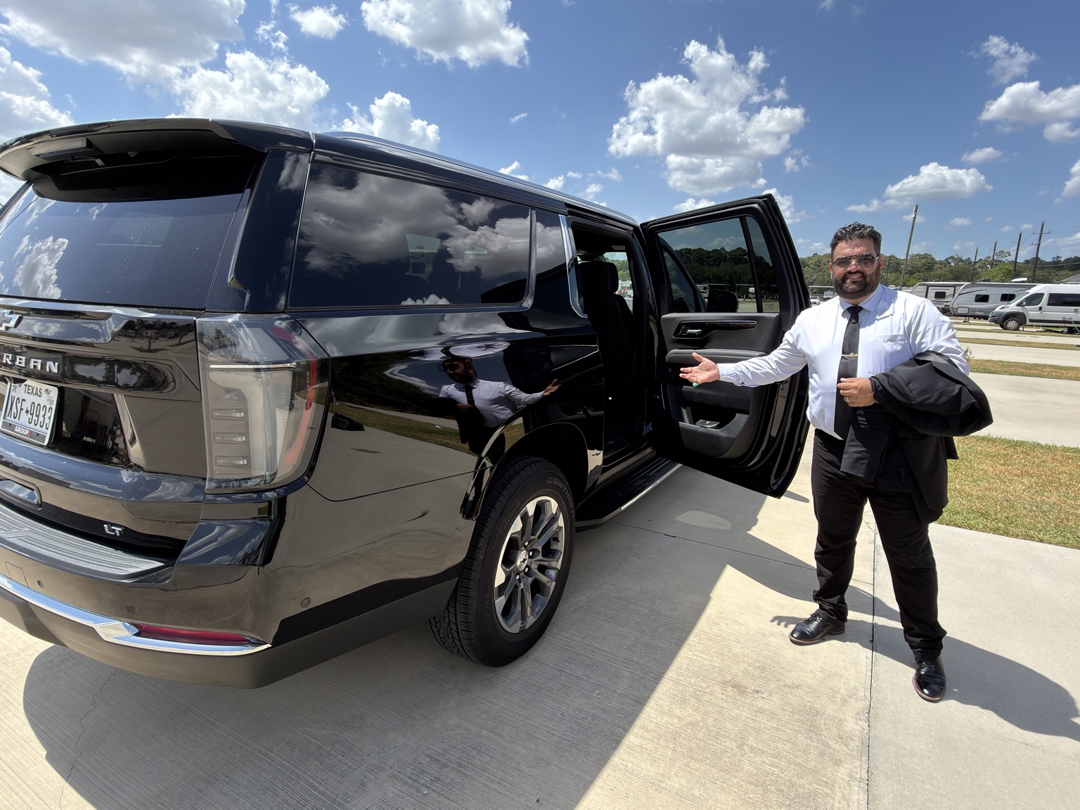 Euvico Executive chauffeur holding the rear door open